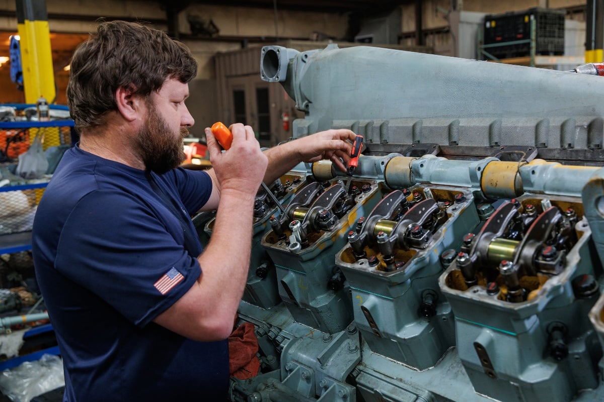 Labord Products employee working on Mitsubishi marine engine